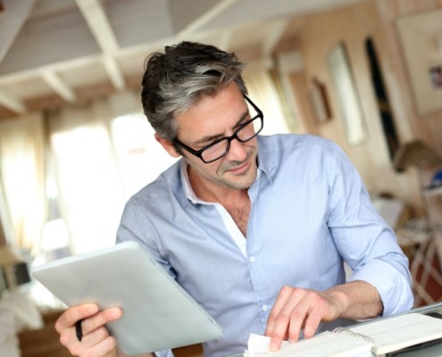 Handsome businessman with eyeglasses working from home